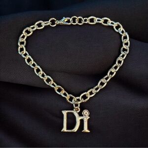 Diamond International gold tone charm bracelet